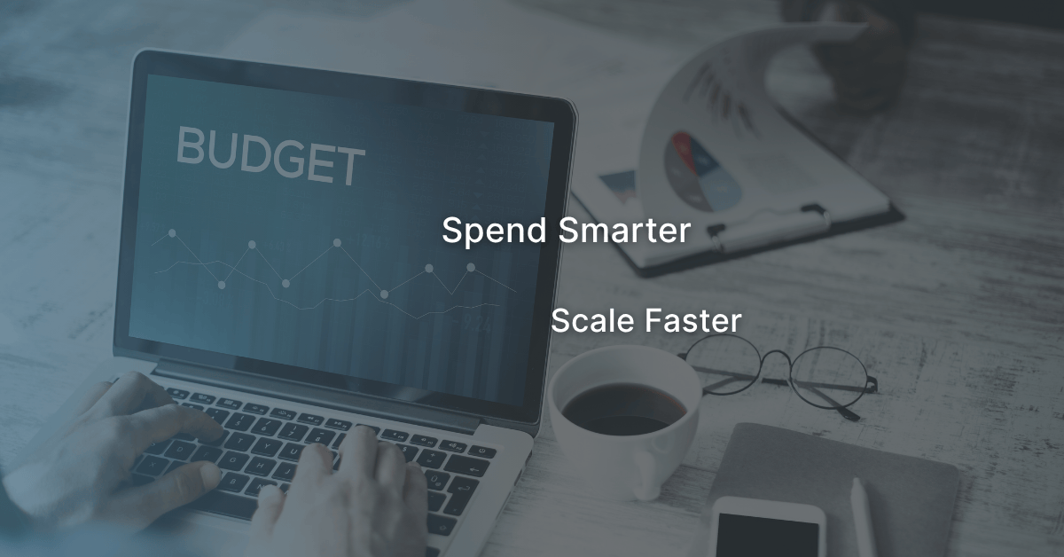 A B2B marketing team analyzing ad performance data together to plan how to use a $10K budget strategically for scalable growth
